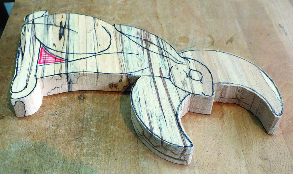 Wooden hare in progress on table