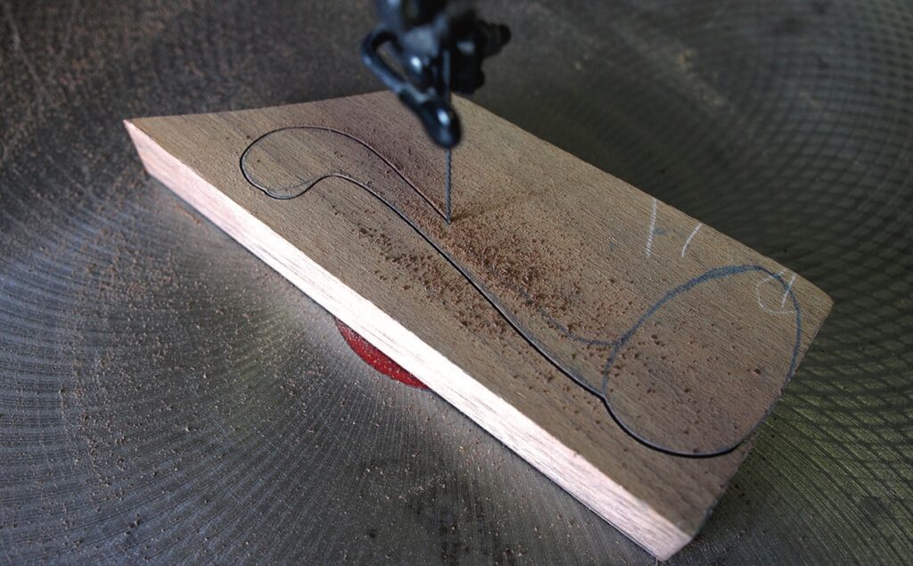 Scroll saw cutting curved wood piece