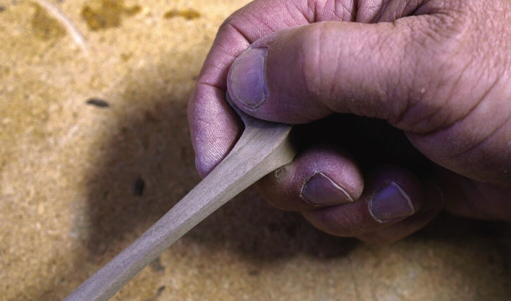 Close-up of hand carving wood