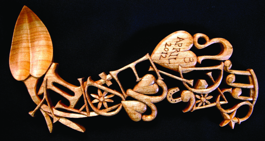 Intricate wooden lovespoon carving with symbolic designs.