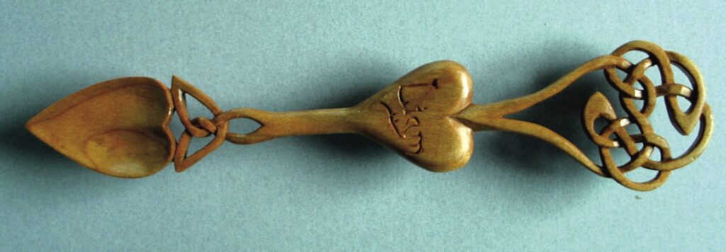 Intricate wooden lovespoon with Celtic designs.