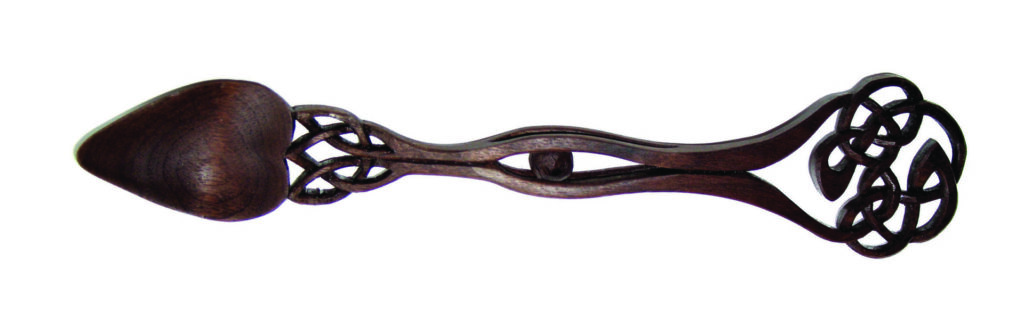 Intricately carved wooden Celtic love spoon