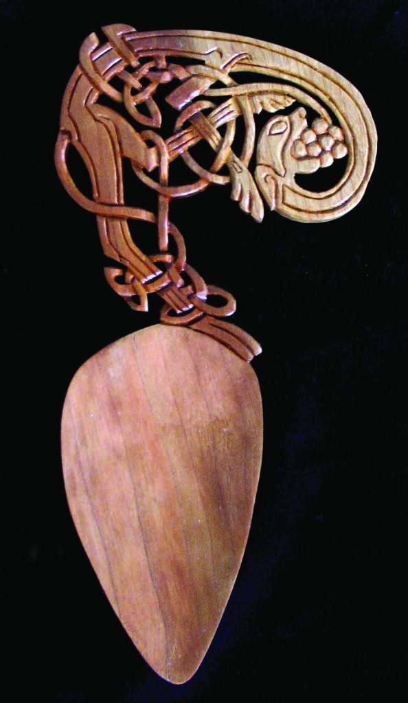 Intricately carved wooden spoon with Celtic design.
