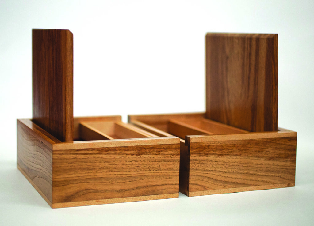 Two open wooden cases on white background.