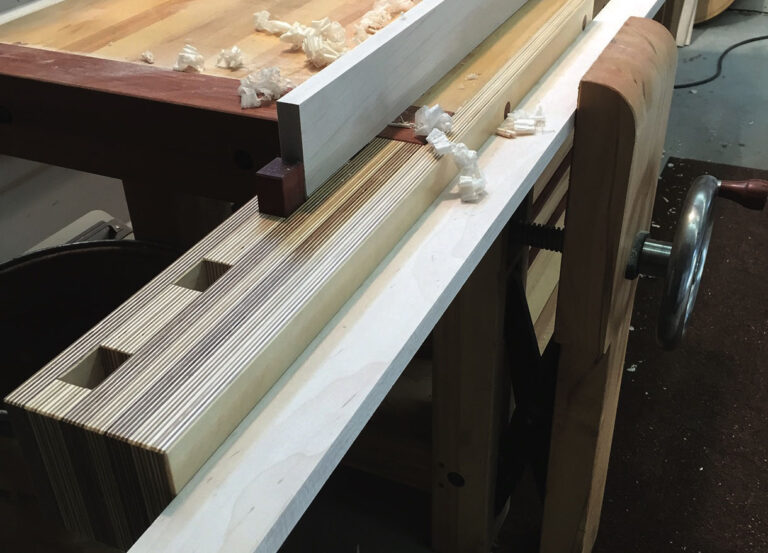 Wooden workbench with wood shavings and vice