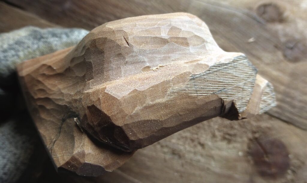 Close-up of carved wooden object in progress
