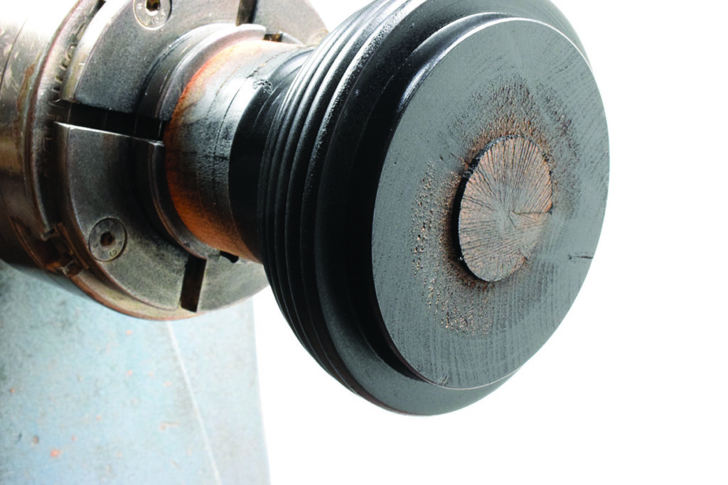 Close-up of a metal lathe chuck.