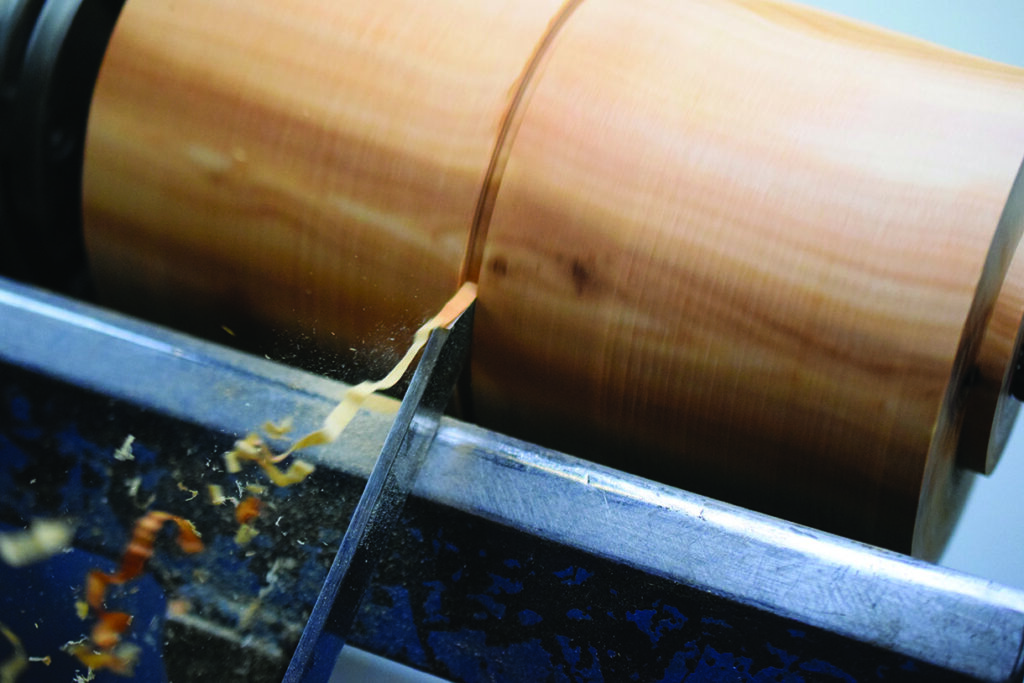 Wood lathe peeling wood shavings during crafting