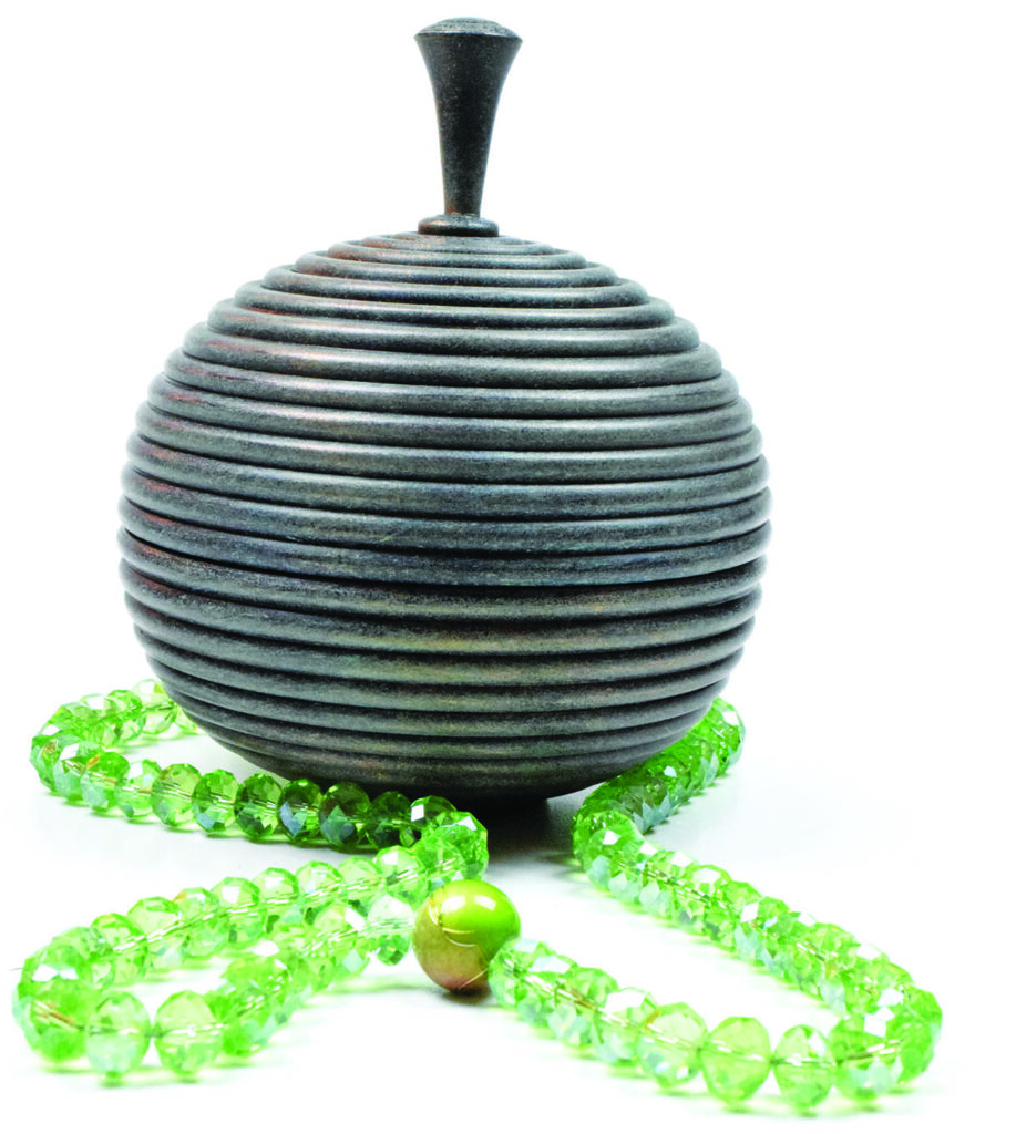 Decorative wooden container with green beads