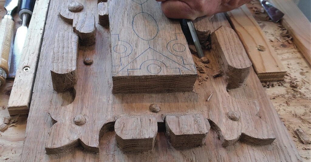 Close-up of detailed wood carving in progress.