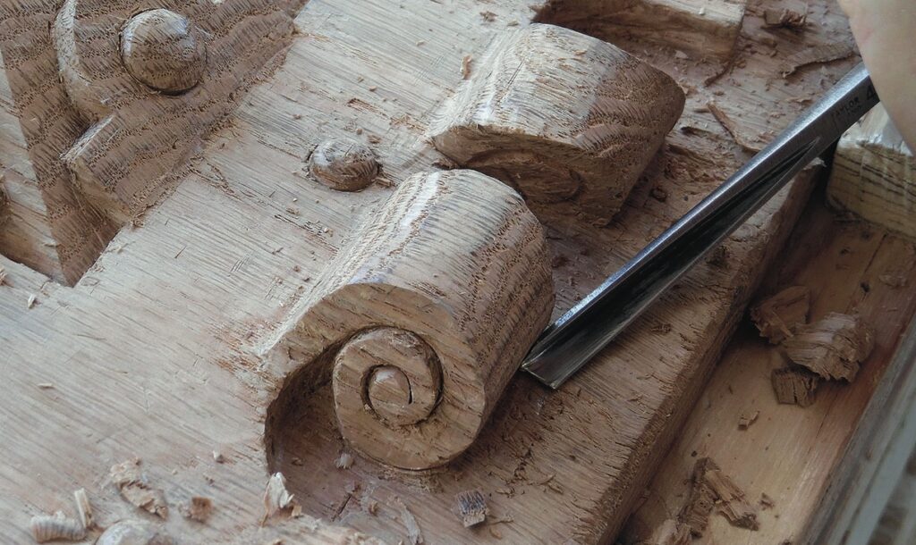 Intricate wood carving with chisel detail.