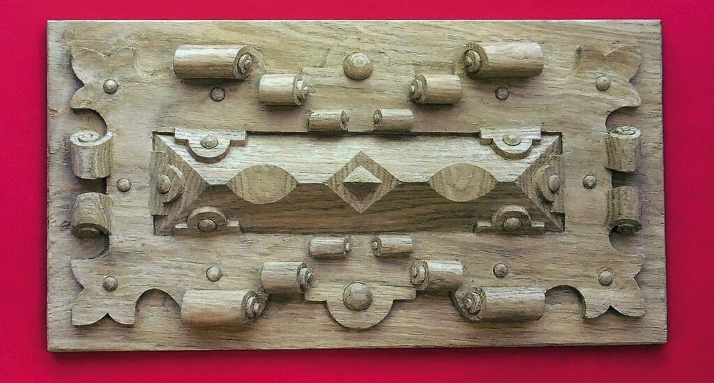 Intricate wooden carving on red background