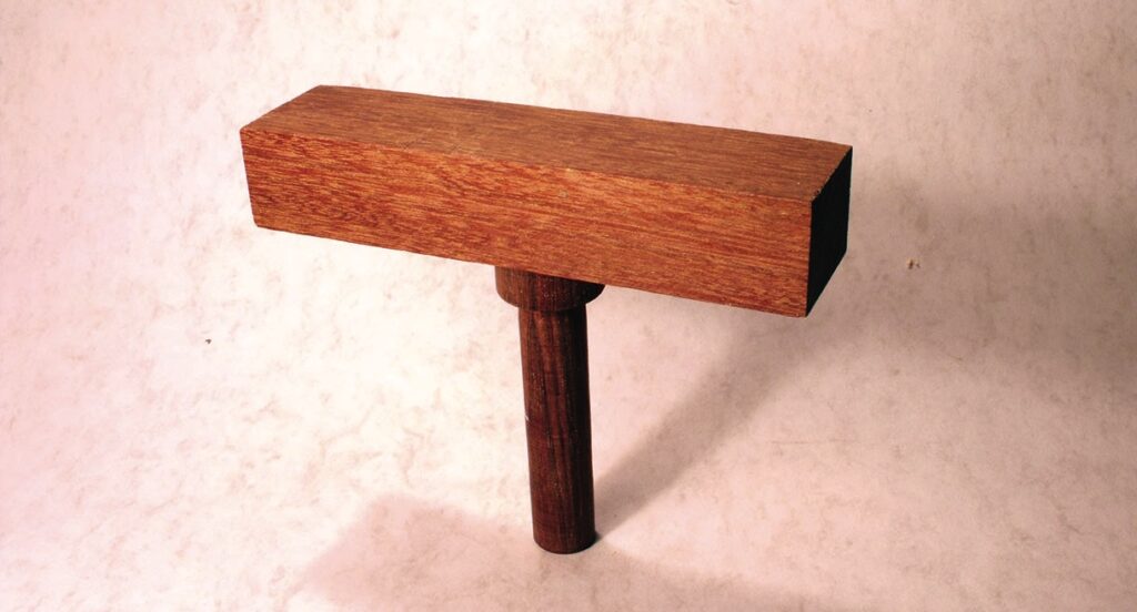 Wooden mallet on light background
