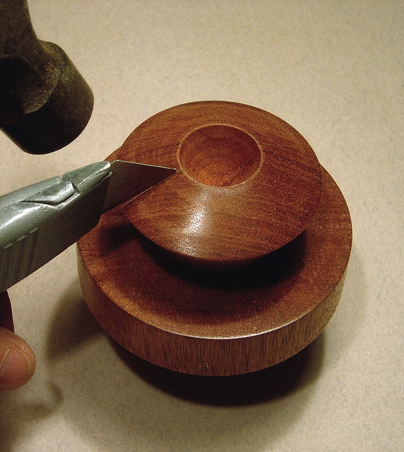 Cutting brown wood with utility knife.