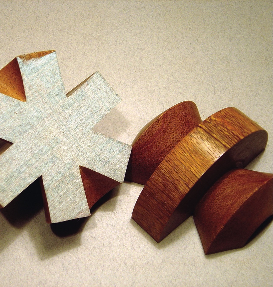 Wooden asterisk puzzle pieces on textured background.