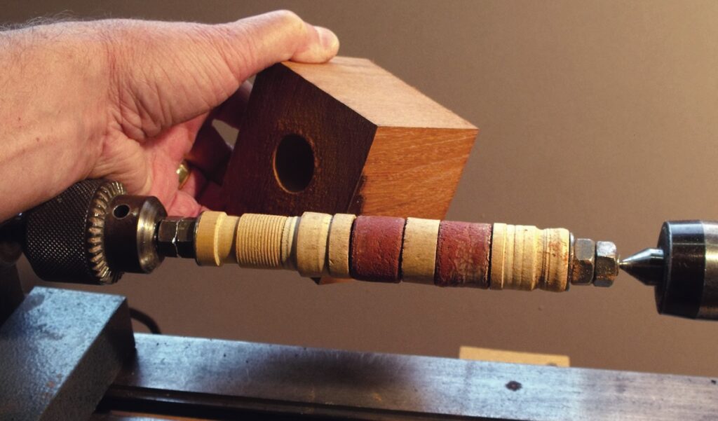 Wood turning on a lathe with wooden block.