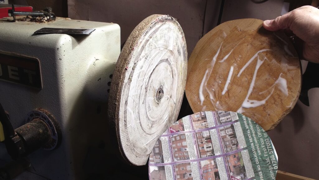 Wood turning disc with glue and paper.
