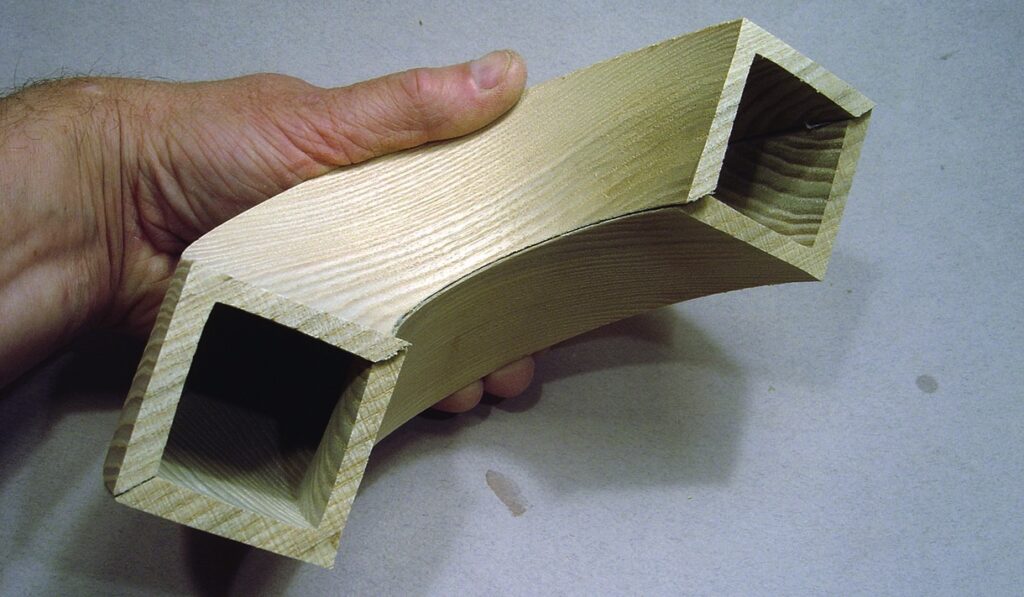 Hand holding flexible wooden beam example