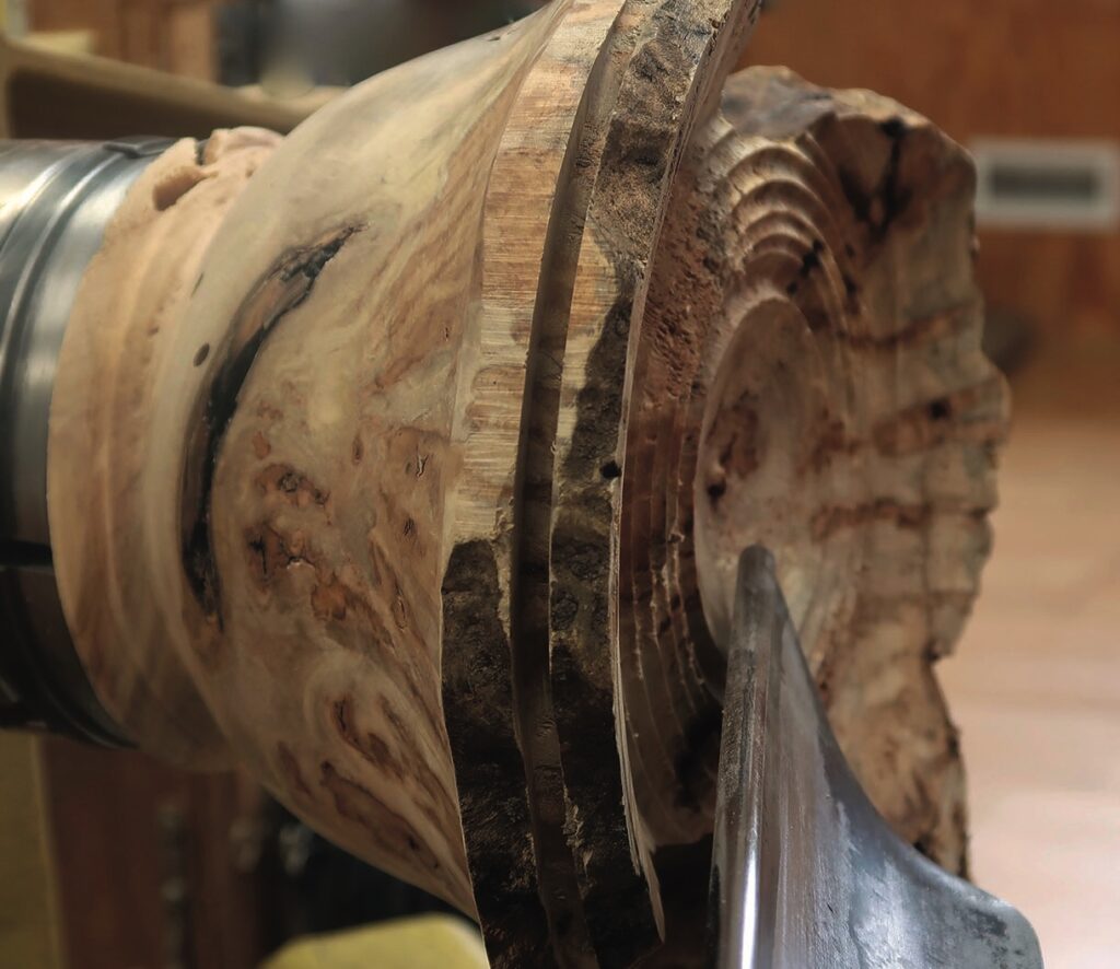 Close-up of woodturning process on lathe machine.