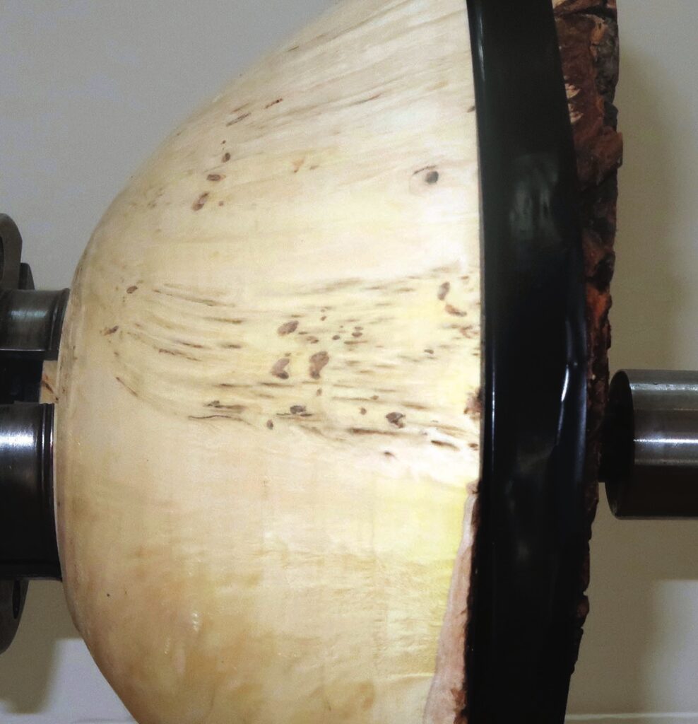 Close-up of wooden bowl on a lathe.