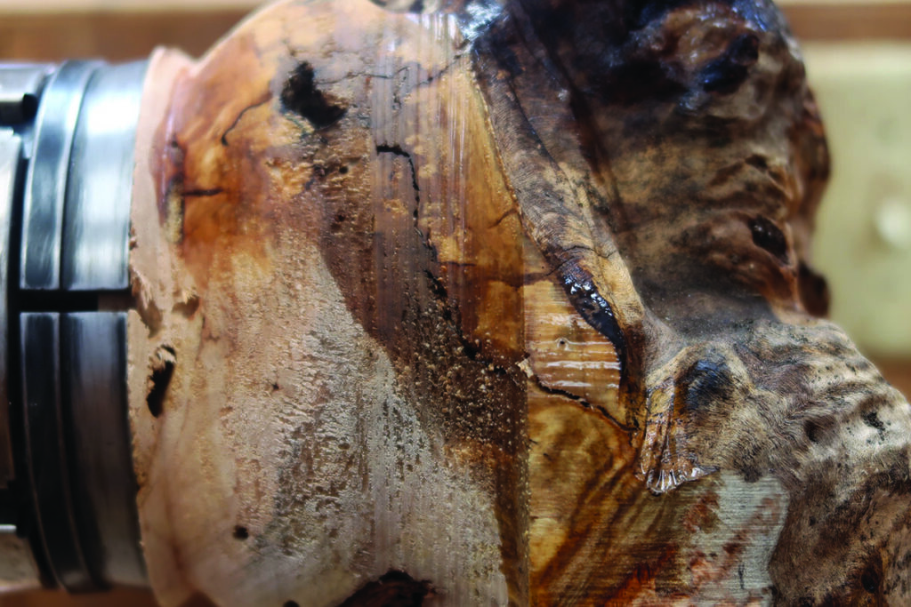 Close-up of wood on lathe, showing grain details.