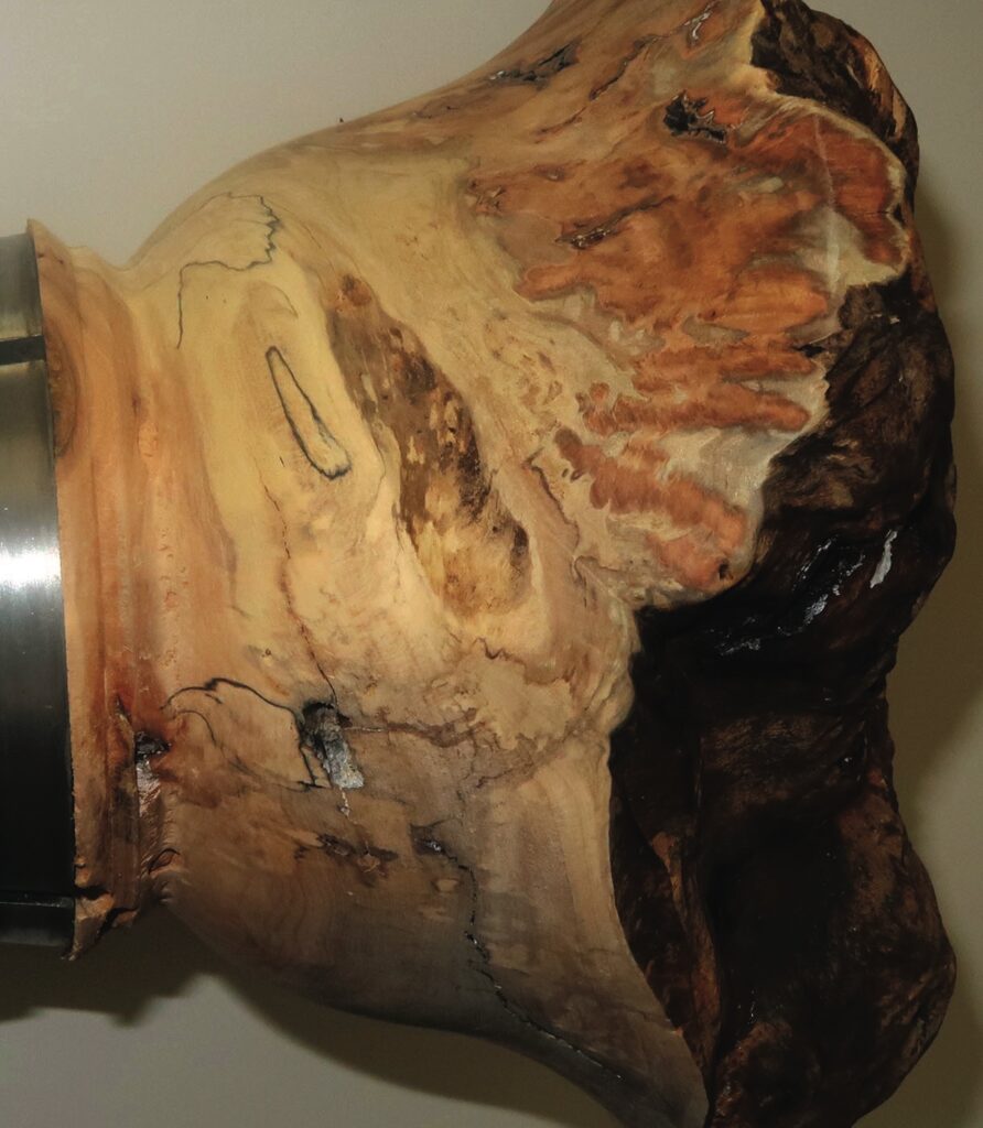 Close-up of polished wooden sculpture detail.