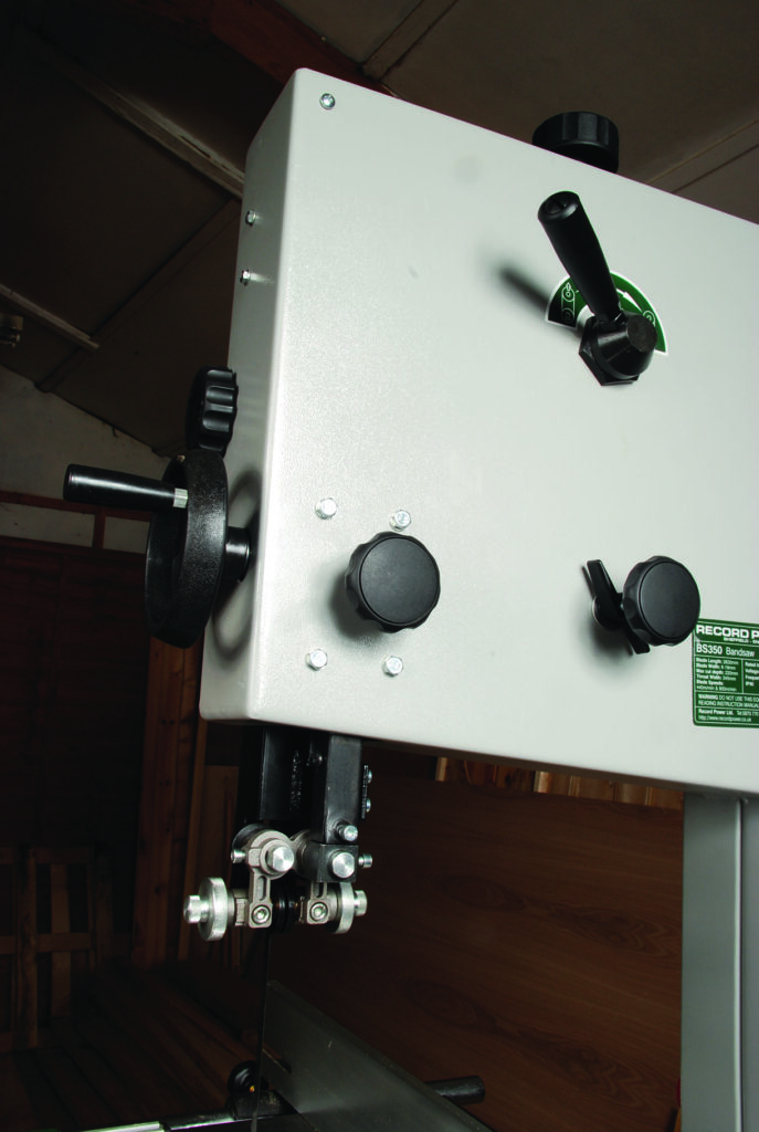 Close-up of industrial bandsaw machine controls.