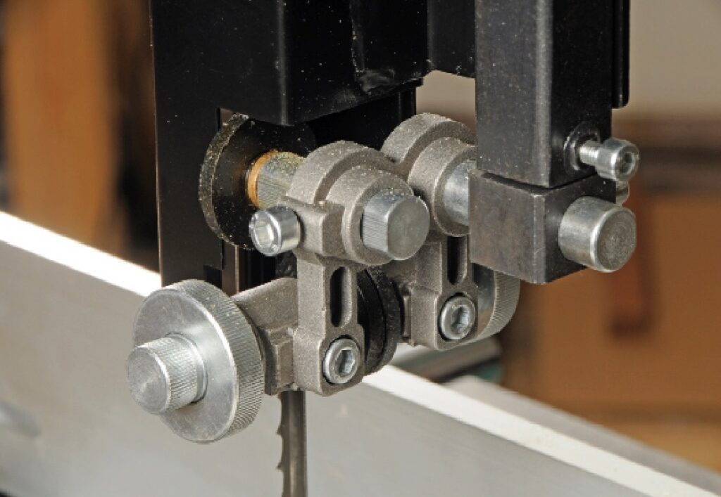 Close-up of industrial band saw blade mechanism.