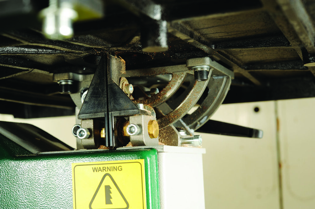 Close-up of industrial machinery with warning sign.