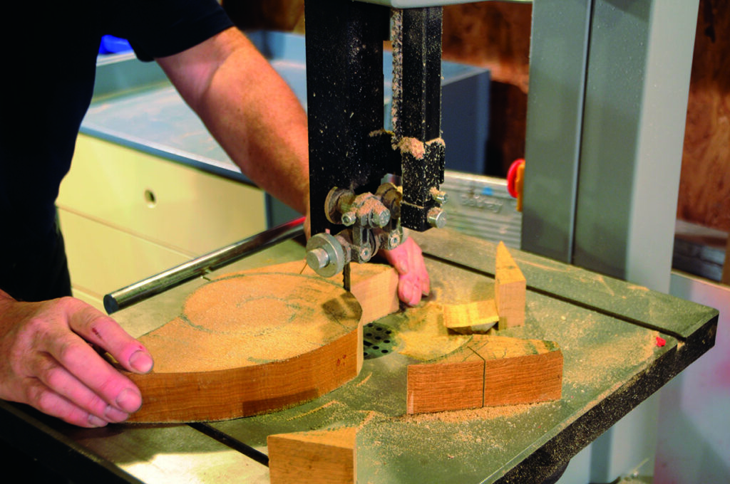 Person using bandsaw for wood cutting