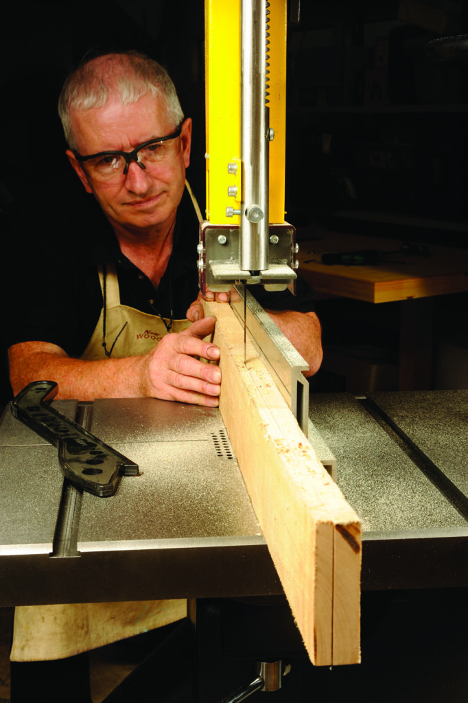 Man using bandsaw to cut wood