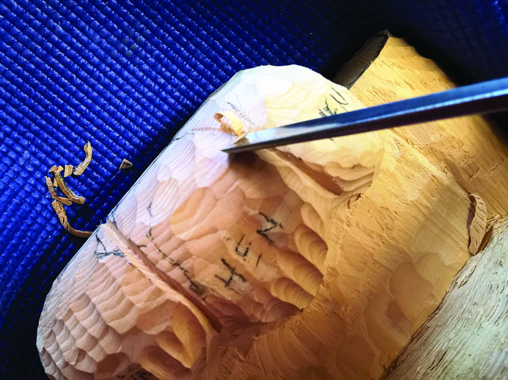 Wood carving in progress with chisel