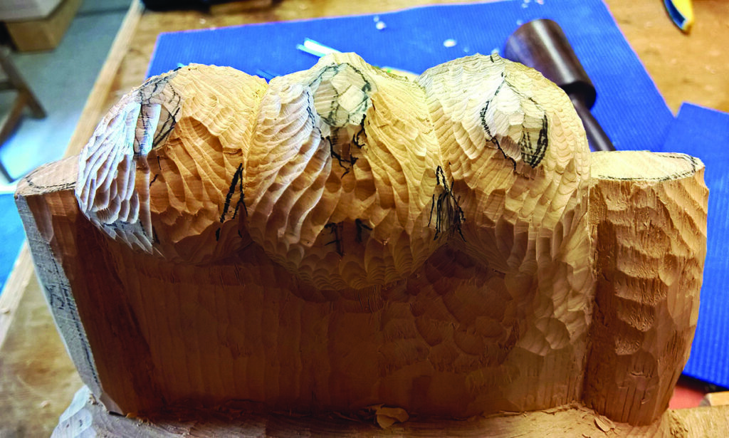 Wood carving in progress with detailed textures.