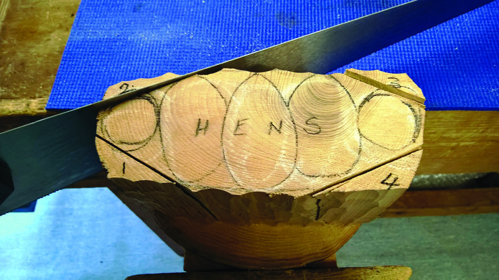 Saw cutting round wood piece with numbers marked.