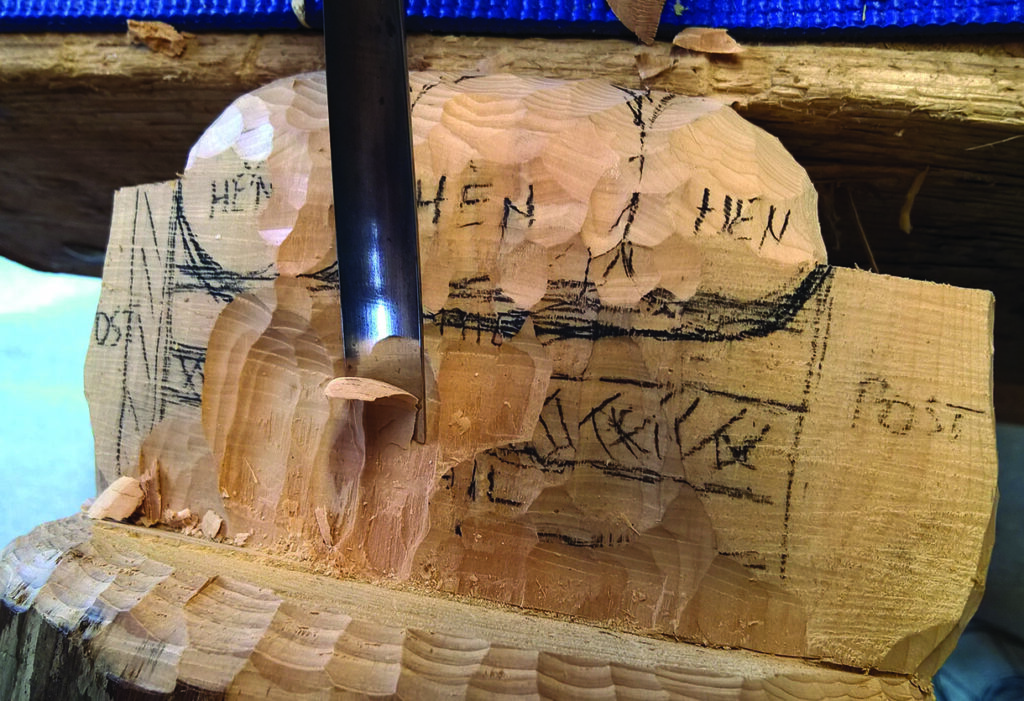 Wood carving with chisel, unearthing hidden design.