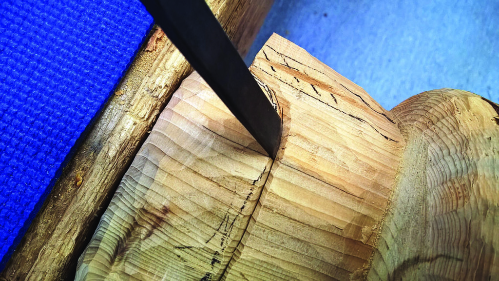 Close-up of wood being carved with chisel