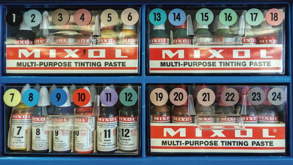 Mixol tinting paste bottles in colourful display boxes.