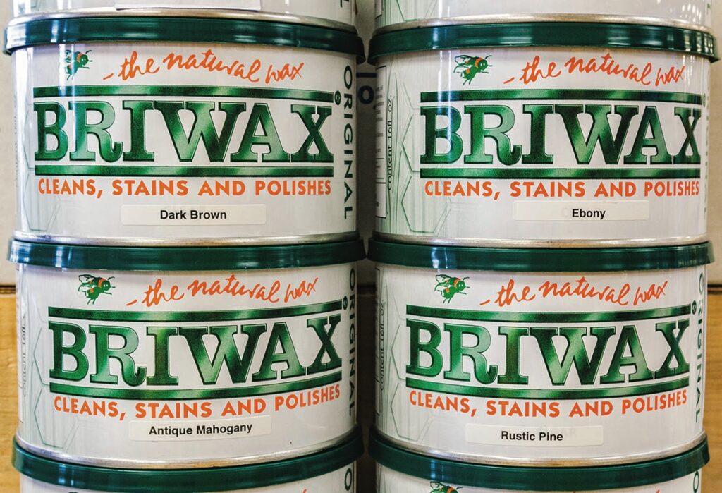 Four tins of Briwax in different colours.
