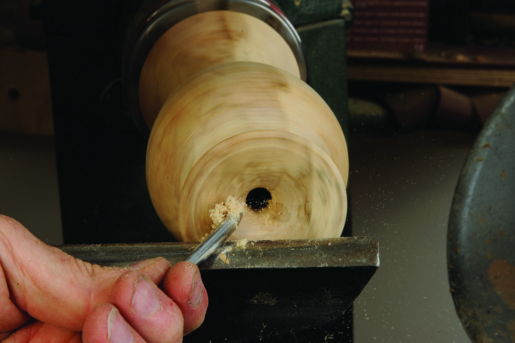 Woodturning in action on a lathe machine.