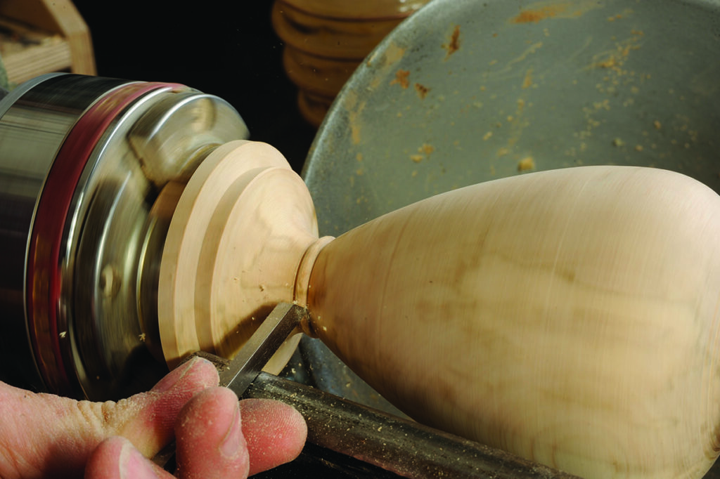 Woodturning with chisels on spinning lathe.