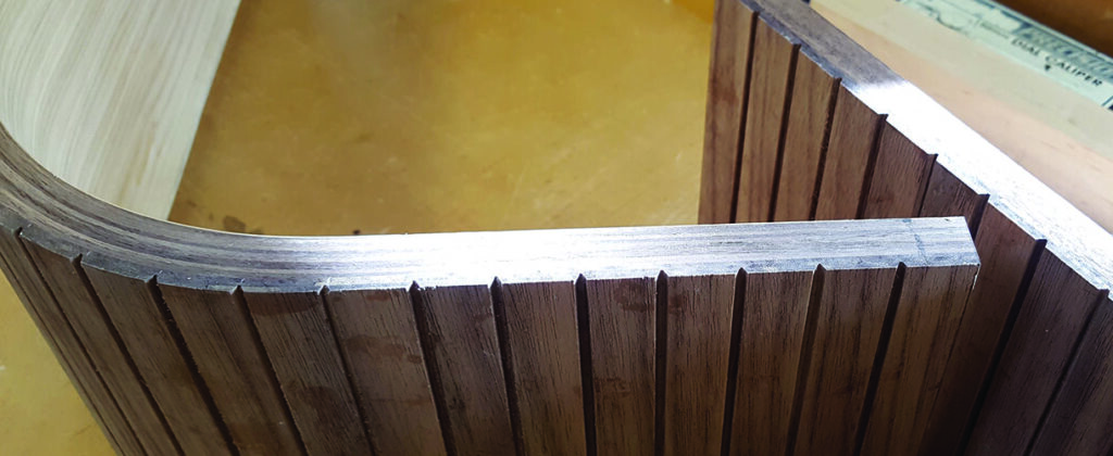 Curved wooden laminate on a workshop table.