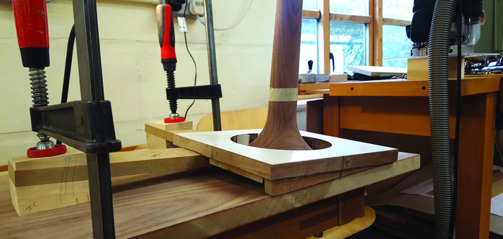 Woodworking with clamps in a workshop setting.
