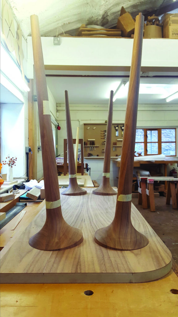 Wooden table legs upside down in workshop