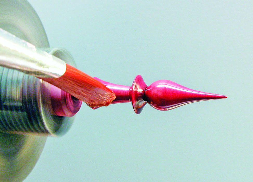 Brush painting spinning metallic object