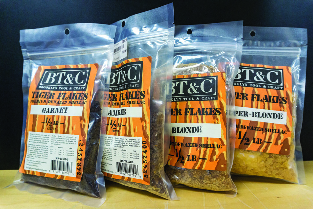 BT&C shellac flakes packages displayed in a row.