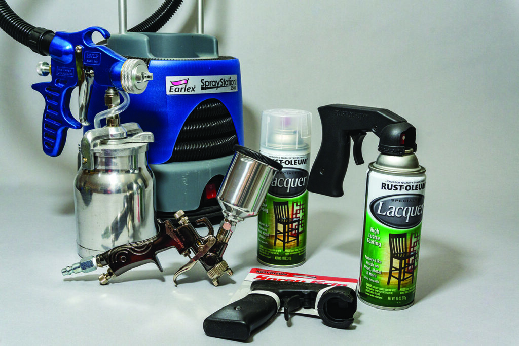 Paint sprayer and spray cans of lacquer.