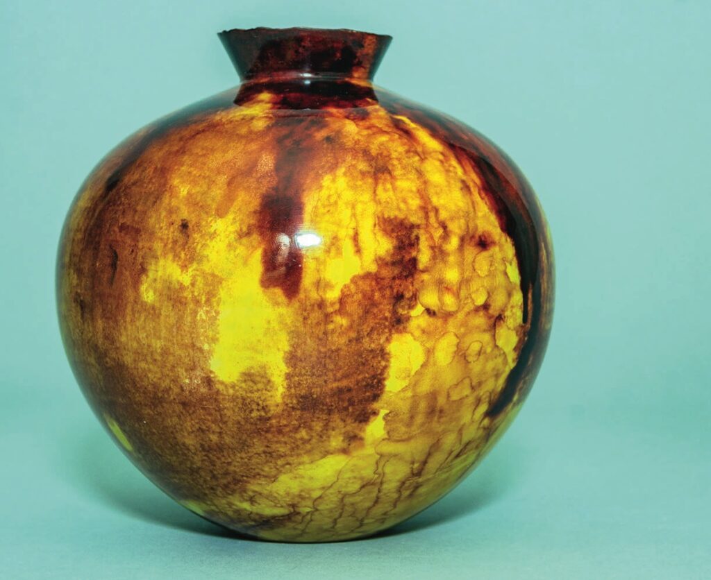 Round ceramic vase with yellow and brown glaze