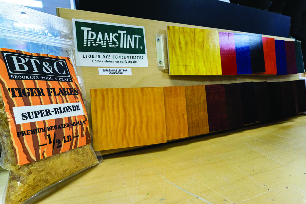 Wood stain samples with dye and shellac products.