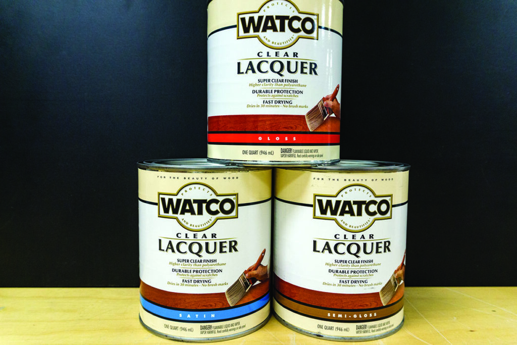 Three cans of Watco clear lacquer on display.