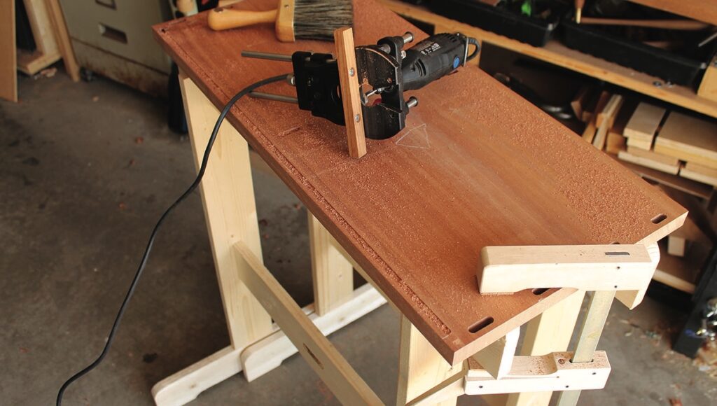Router set up on wooden workbench.